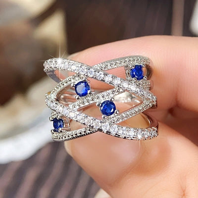 Multiple Line Crossing Sapphire with Zircon Ring