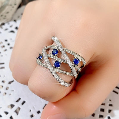 Multiple Line Crossing Sapphire with Zircon Ring