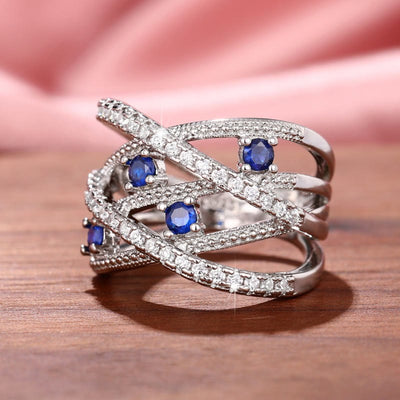 Multiple Line Crossing Sapphire with Zircon Ring