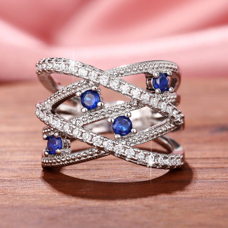 Multiple Line Crossing Sapphire with Zircon Ring