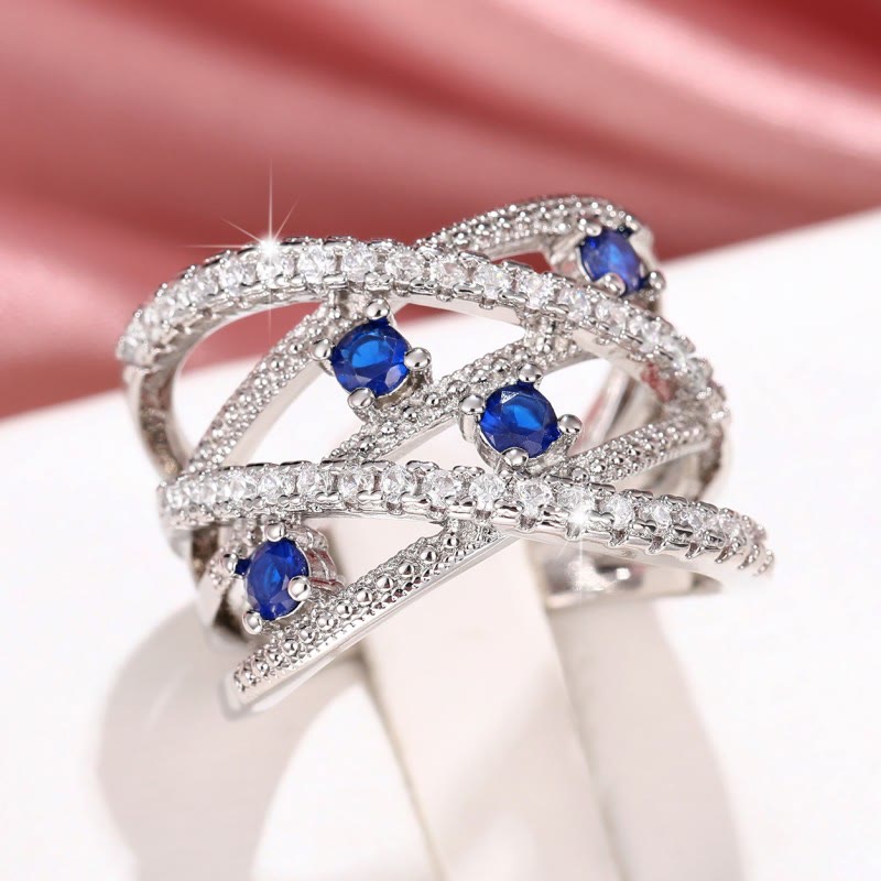 Multiple Line Crossing Sapphire with Zircon Ring