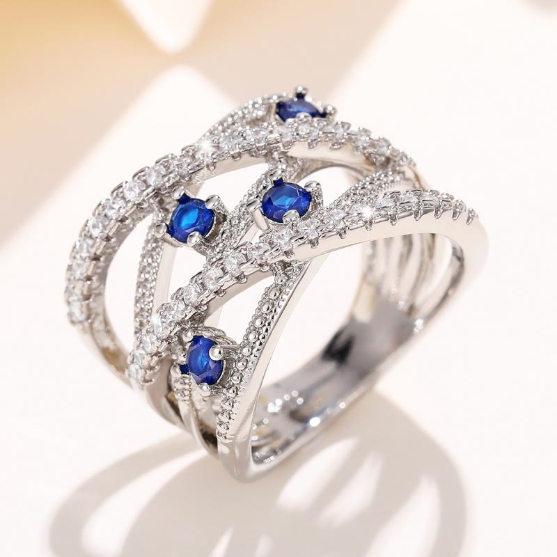 Multiple Line Crossing Sapphire with Zircon Ring